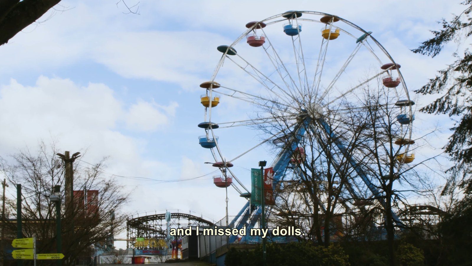The PNE ferris wheel and wooden roller coaster seen from Hastings Park, under a line from the poem